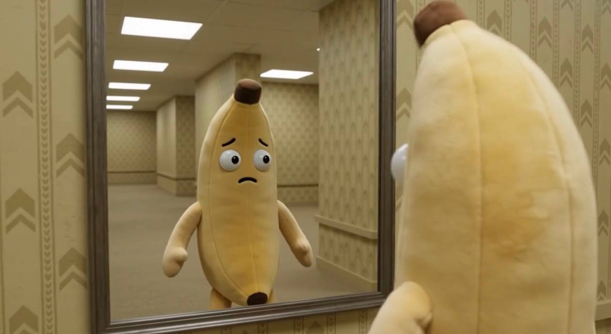 Banana character looking into a mirror in the rooms